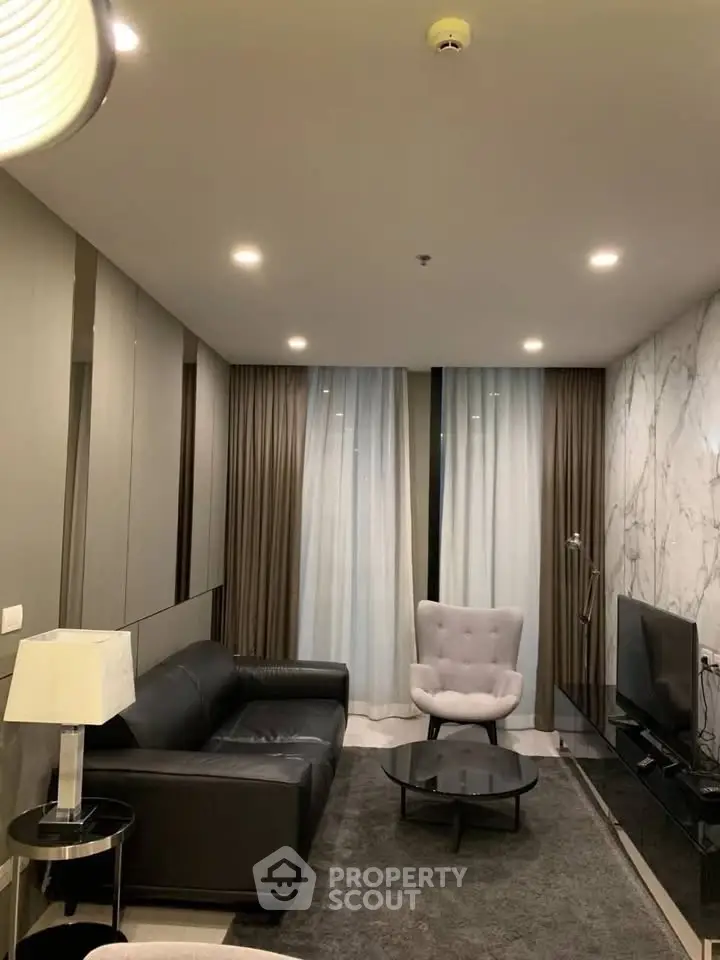 Modern living room with sleek furniture and ambient lighting in a stylish apartment.
