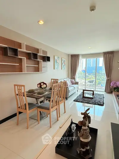 Modern living room with elegant dining area and balcony view in a stylish apartment.