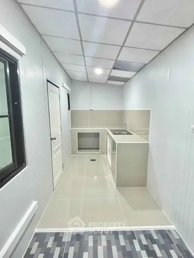 Modern minimalist kitchen with sleek design and tiled flooring