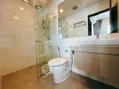 Modern bathroom with glass shower and sleek fixtures