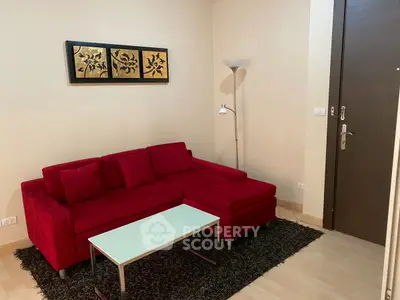 Cozy living room with red sofa and modern decor in a stylish apartment.