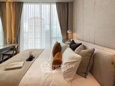 Luxurious bedroom with city view, elegant decor, and natural light through large windows.
