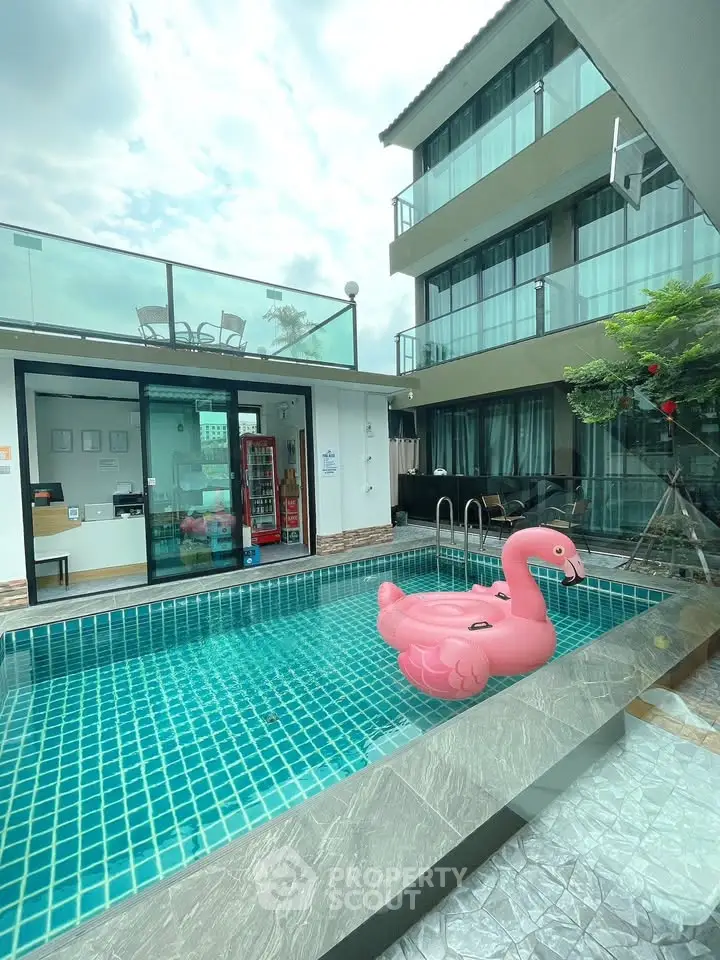 Luxurious villa with private pool and modern architecture, featuring a pink flamingo float for ultimate relaxation.