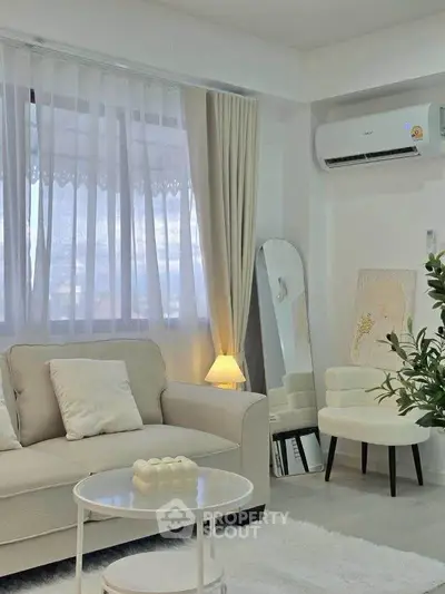 Chic living room with cozy sofa, elegant decor, and natural light.