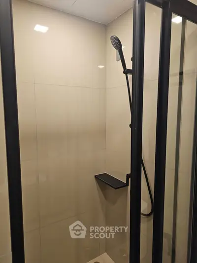 Modern bathroom shower with sleek black fixtures and glass enclosure