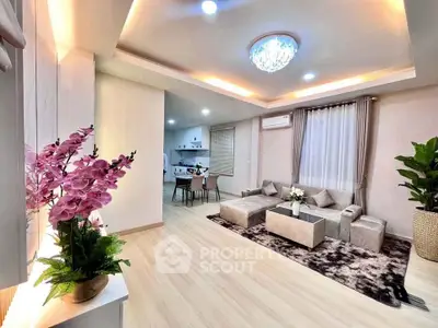 Luxurious modern living room with elegant decor and open kitchen layout, featuring stylish lighting and cozy seating.