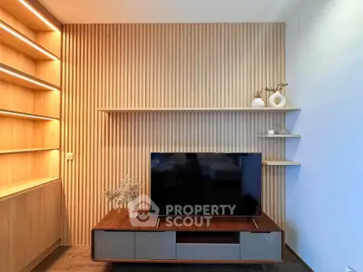 Modern living room with stylish wooden paneling and sleek TV setup