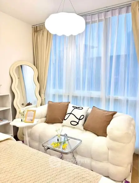 Chic living room with plush sofa and elegant decor in bright natural light.