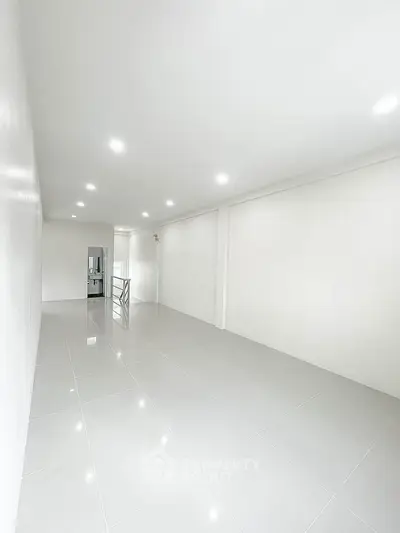 Spacious minimalist interior with bright lighting and sleek tile flooring