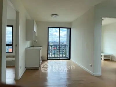 Spacious apartment with balcony and city view, featuring modern open layout and natural light.