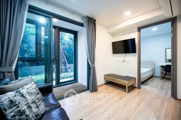 Modern living room with garden view and adjacent bedroom