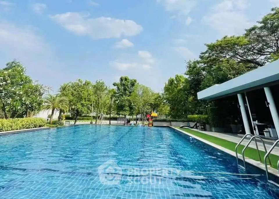 Luxurious outdoor pool surrounded by lush greenery and modern architecture