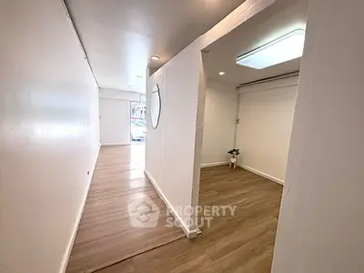 Spacious interior with modern flooring and bright lighting, ideal for versatile use.