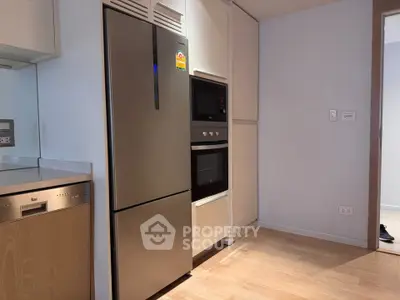 Modern kitchen with stainless steel appliances and sleek cabinetry