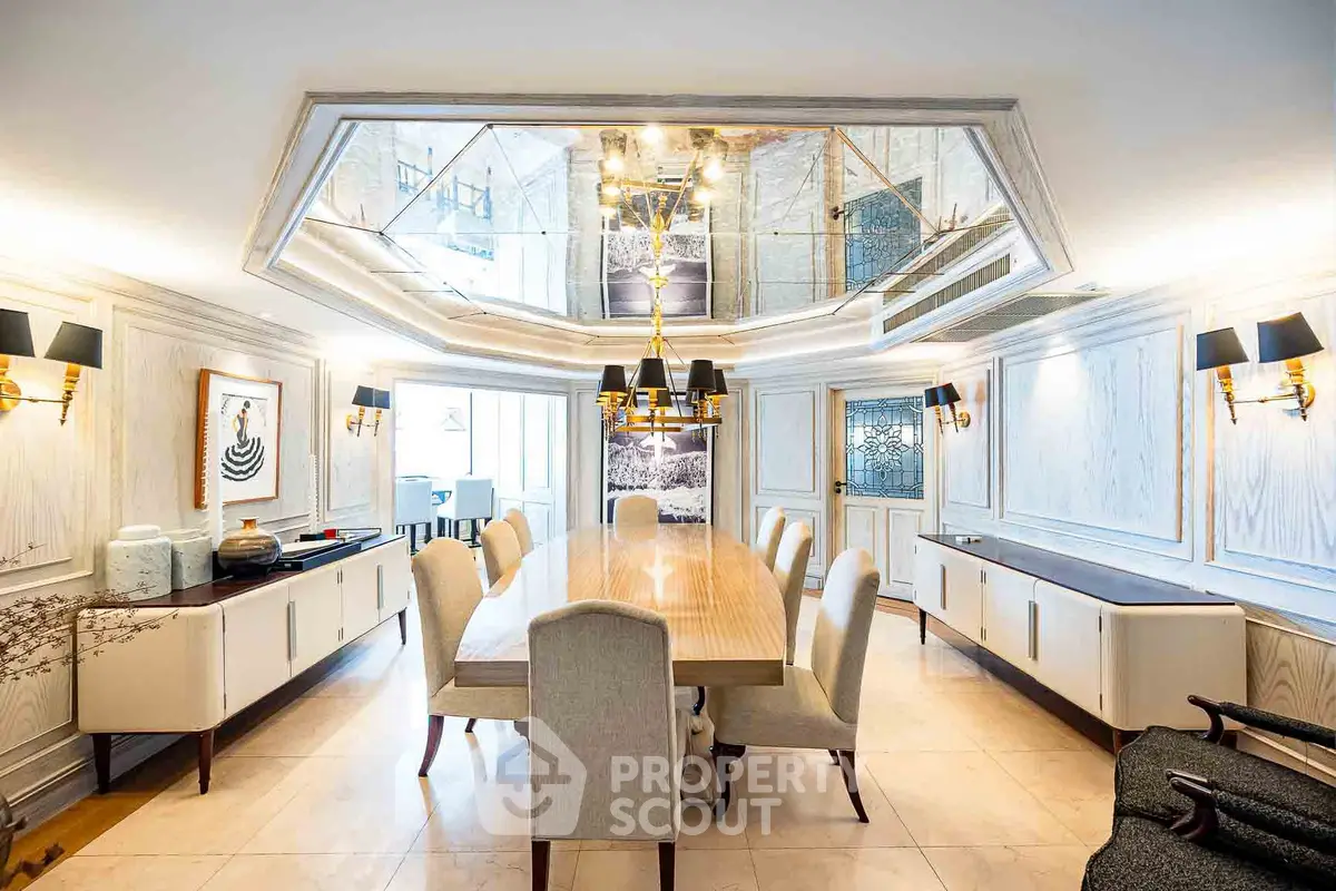 Luxurious dining room with elegant chandelier and mirrored ceiling, perfect for entertaining guests.