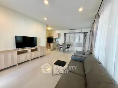 Spacious modern living room with sleek furniture and large windows