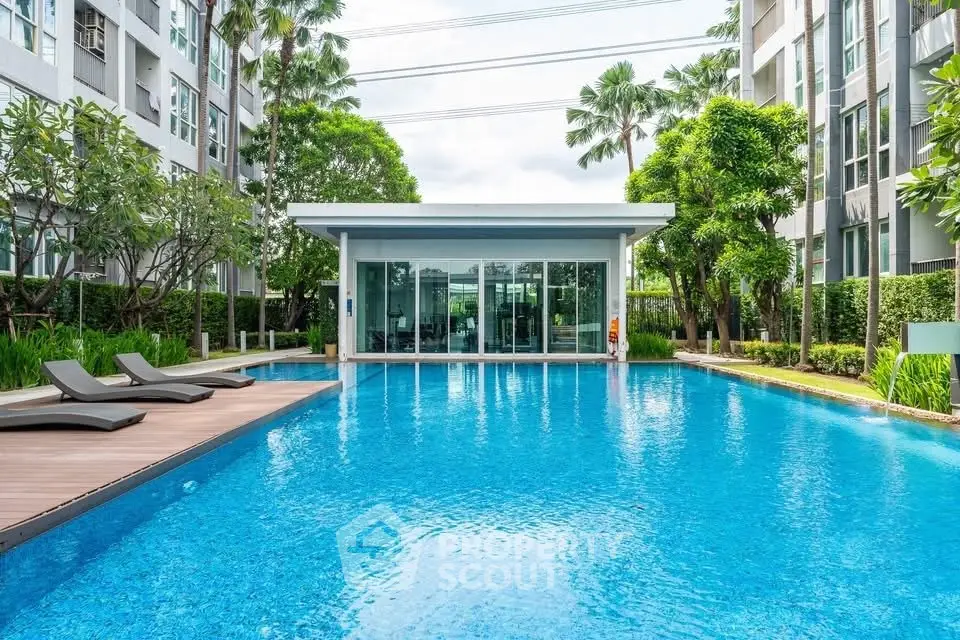 Luxurious condominium with stunning pool and lush greenery, perfect for relaxation and leisure.
