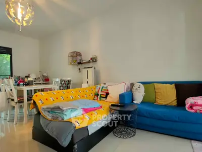 Cozy living room with colorful sofa and dining area, perfect for family gatherings.