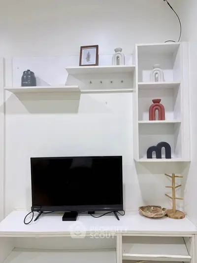 Modern living room with stylish shelving and flat-screen TV, perfect for contemporary urban living.