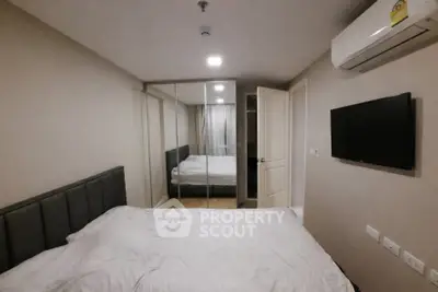 Modern bedroom with mirrored closet and air conditioning in a cozy apartment.