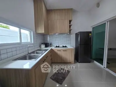 Modern kitchen with sleek wooden cabinets and stainless steel appliances