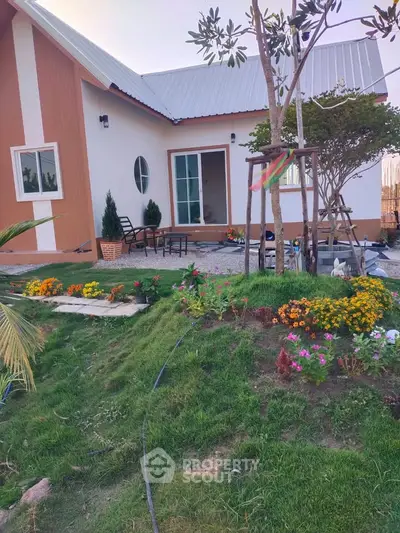 Charming single-story home with lush garden and cozy patio area, perfect for outdoor relaxation.