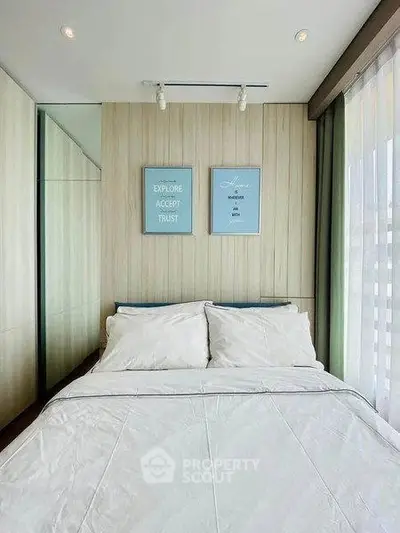 Cozy bedroom with modern decor and large window for natural light