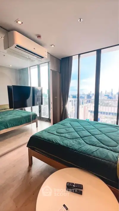Modern bedroom with city view, large windows, and sleek design.