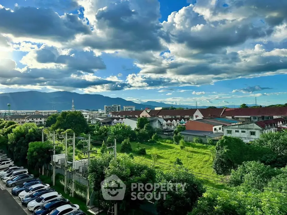 Scenic view of residential area with lush greenery and mountain backdrop
