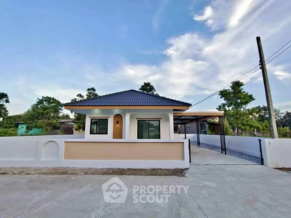 Charming single-story house with modern design and spacious driveway in serene neighborhood.