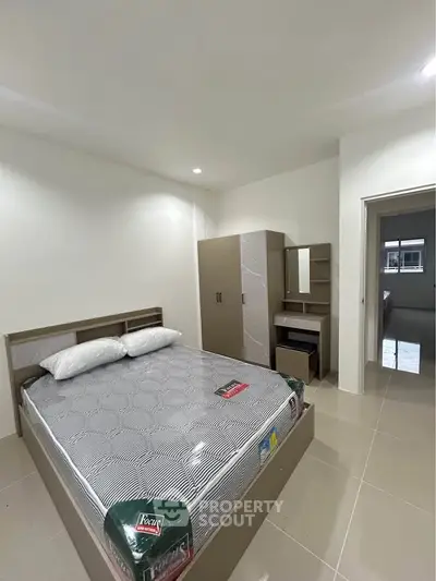 Modern bedroom with sleek furniture and neutral tones, perfect for a cozy retreat.