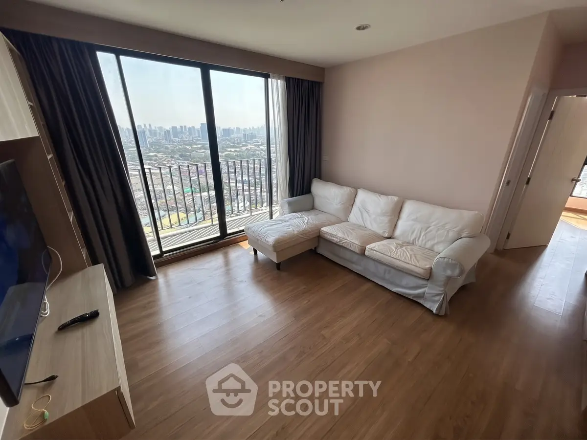 Spacious living room with city view and cozy white sofa in modern apartment