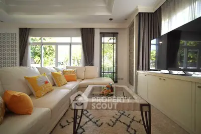 Luxurious living room with plush white sofa, large windows, and modern decor in a bright, inviting space.