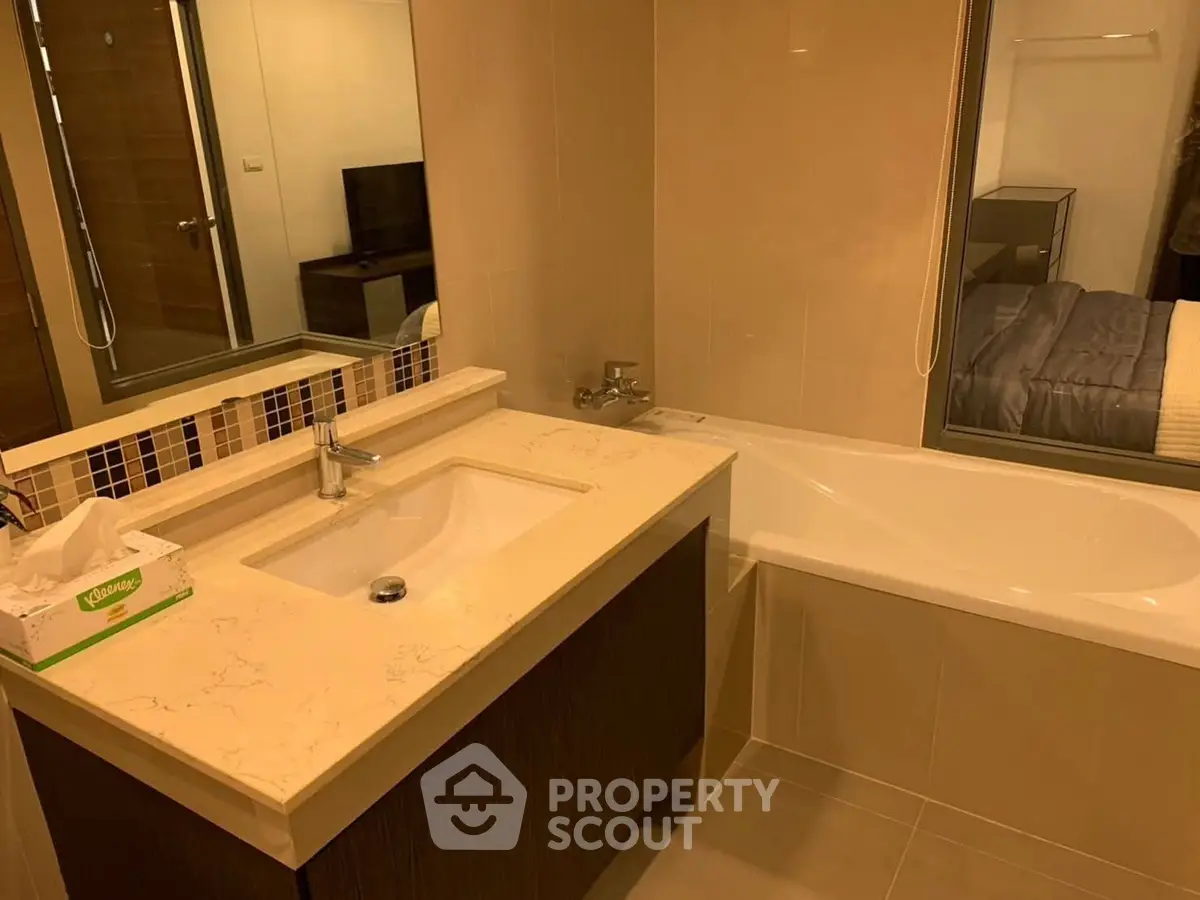 Modern bathroom with sleek vanity and bathtub in a stylish apartment