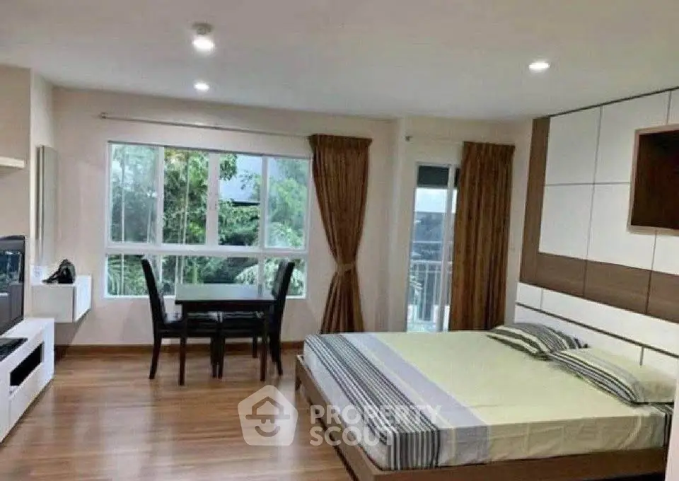 Spacious modern bedroom with large window and stylish decor