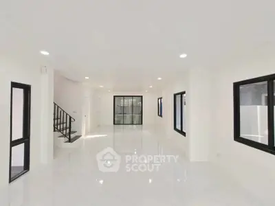 Spacious modern living room with sleek design and large windows