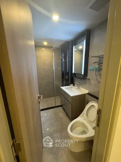 Modern bathroom with sleek fixtures and glass shower enclosure