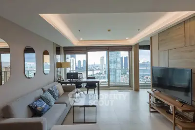 Spacious modern living room with city view, stylish decor, and ample natural light.