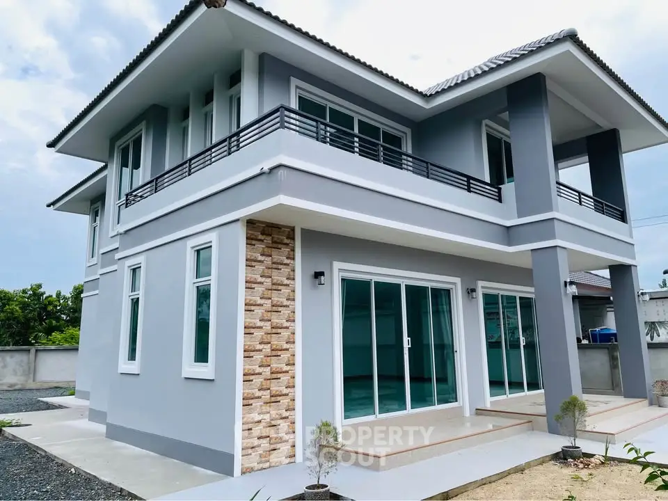 Modern two-story house with large windows and stylish exterior design