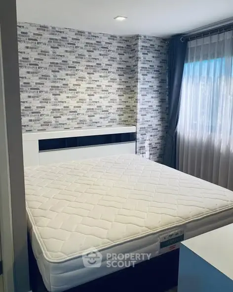 Modern bedroom with stylish brick accent wall and large window