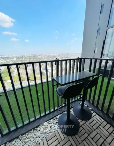 Stunning balcony with panoramic city view and modern seating area