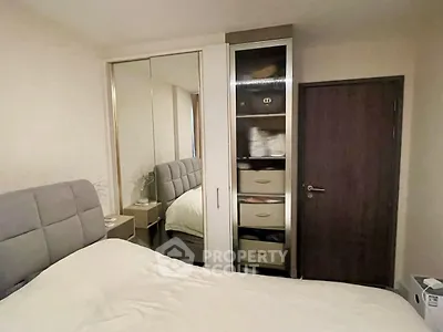 Cozy bedroom with mirrored wardrobe and modern decor