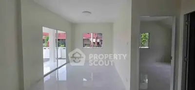 Spacious unfurnished living room with large windows and natural light