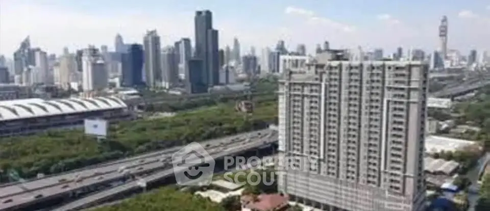 Stunning cityscape view with modern high-rise building and lush greenery, perfect for urban living.