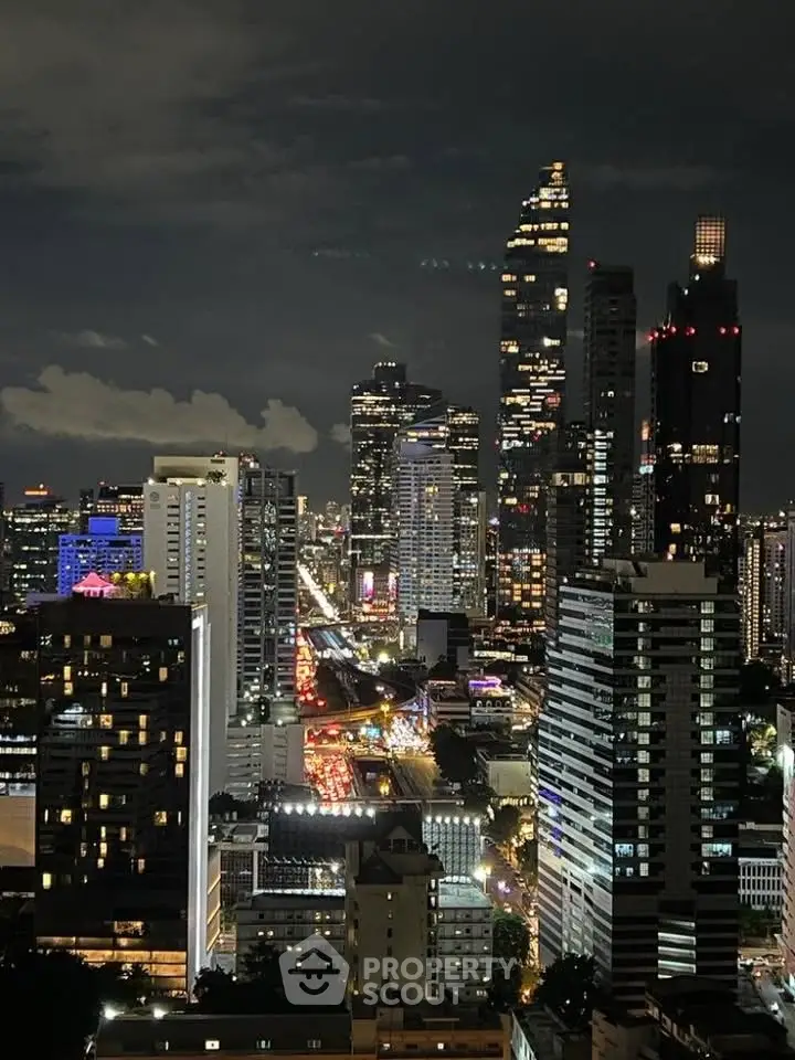 Stunning nighttime cityscape view showcasing illuminated skyscrapers and bustling streets.