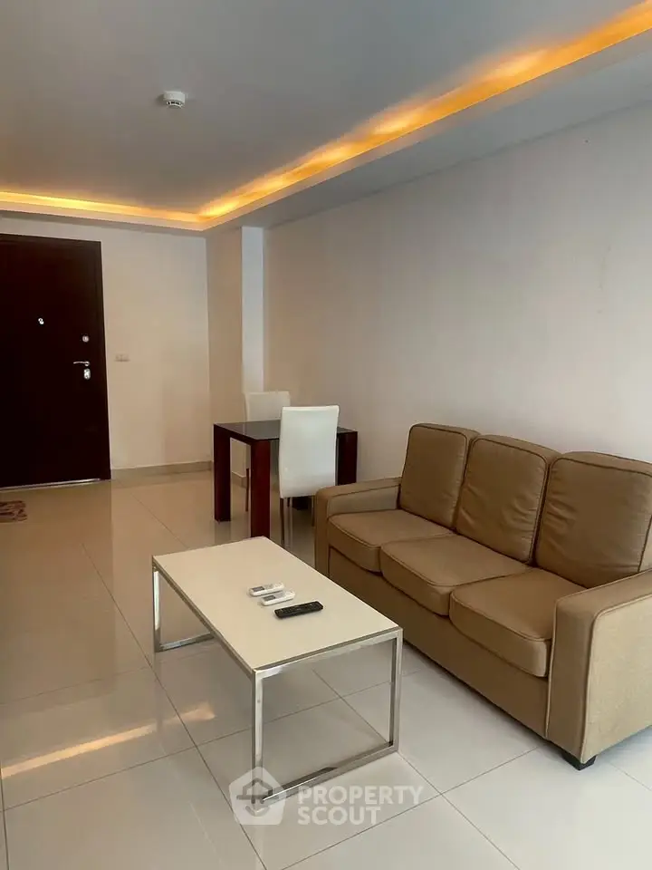 Modern living room with sleek furniture and ambient lighting, perfect for relaxation and entertainment.