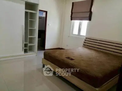 Spacious bedroom with modern design and ample storage space.