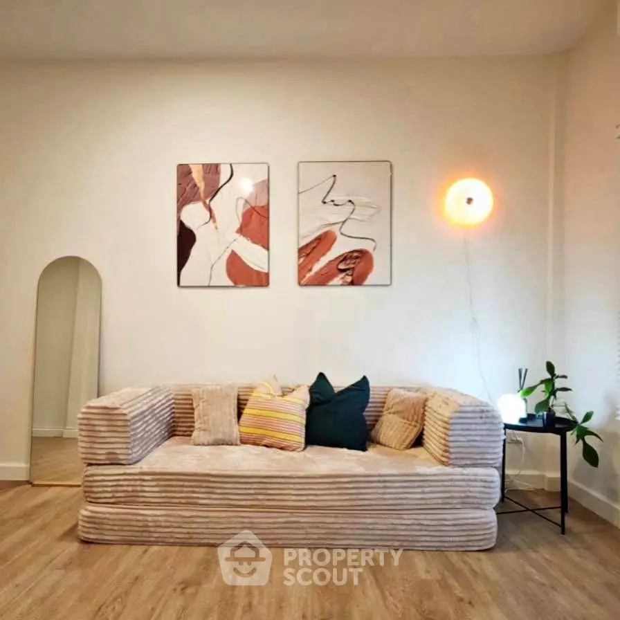 Stylish living room with modern decor and cozy sofa, perfect for relaxation.