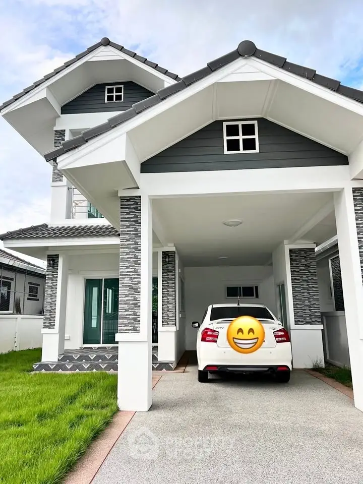 Modern two-story house with carport and stylish exterior design.