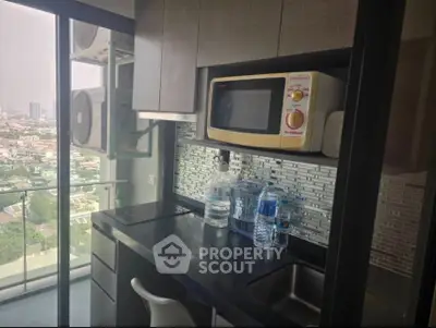 Modern kitchen with microwave and city view from balcony